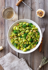 Pasta with broccoli, pesto sauce and nuts. Italian cuisine. Healthy eating.