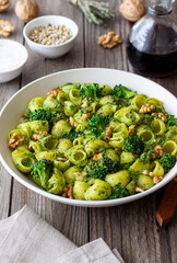 Pasta with broccoli, pesto sauce and nuts. Italian cuisine. Healthy eating.