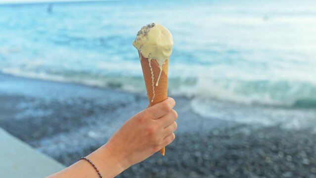 Melting ice cream treat feasting at beach Las Galletas Tenerife Spain 