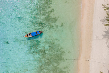 Top view at longtail boats in a blue ocean at the beach of Koh Ngai island Thailand