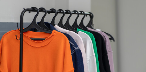 Obraz premium clothes hanger rack with casual textile wear at home