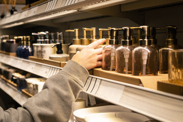 Containers for liquid soap or shampoo with a dispenser is sold in a supermarket.
