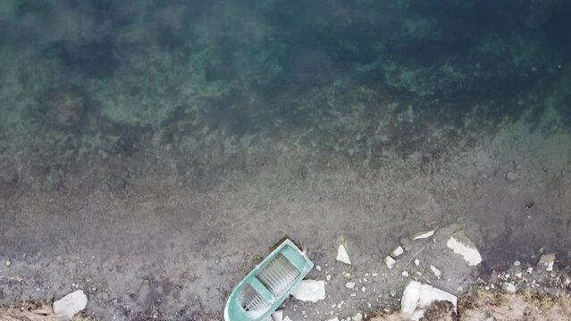An aerial view of a small boat laying on the riverbed of river Adda in Lombardy, Italy 