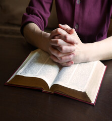 Woman's hands holding a bible