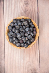 blueberries in a wooden bowl,blueberries in a wooden bowl on a wooden background, healthy food, fruit in a bowl