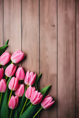 Bunch of pink tulips on wooden surface.