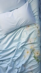 Top view crumpled pale blue rumpled bed with pillows early in the morning.