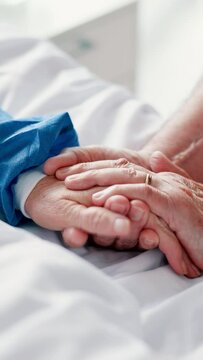 Hospital, bed and holding hands of elderly with care, support and empathy of partner in marriage and healthcare. Life insurance, commitment and caregiver with patient in clinic sick with cancer virus