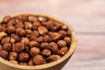 close up of hazelnuts ready for cleaning, hazelnut harvest, coconut background, peeled brown nut kernels, healthy organic bio products, vegetarian, vegan and raw food, healthy fat,hazelnuts in a woode