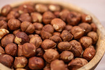 close up of hazelnuts ready for cleaning, hazelnut harvest, coconut background, peeled brown nut kernels, healthy organic bio products, vegetarian, vegan and raw food, healthy fat,hazelnuts in a woode