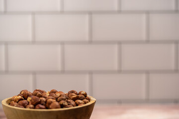 close up of hazelnuts ready for cleaning, hazelnut harvest, coconut background, peeled brown nut kernels, healthy organic bio products, vegetarian, vegan and raw food, healthy fat,hazelnuts in a woode