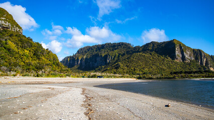 scenic west coast of new zealand south island; paradise beaches with large cliffs and little...