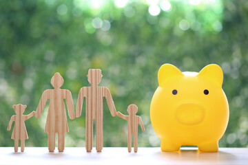 Model family with piggy bank on natural green background,Save money for prepare in future and...