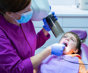 Boy checking his teeth at the dentist's office