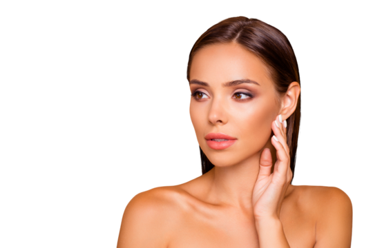 Graceful pretty well-groomed charming lady with naked shoulders look aside she stand isolated on pastel beige background with copy space for text she touch her face by hands