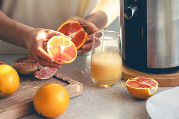 The process of making orange juice in the home kitchen.