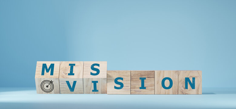 Fliped wooden cubes vision to a mission. Dice form the words vision and mission.