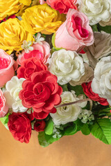 Beautiful bouquet of artificial multicolored flowers in box, close-up, selective focus