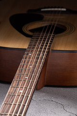 Obraz premium Classical guitar close up. Acoustic guitar on wood background.Music instrument concept