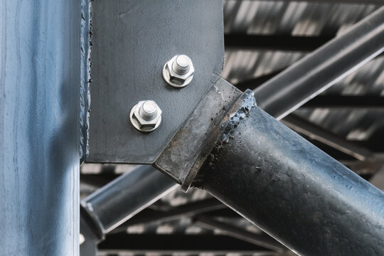 Metal bridge support, bolt and nut connection and weld seam, architectural detail, close-up