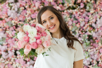 Carefree stylish woman holds flower gift, holiday portrait