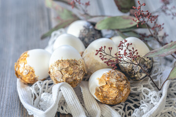 Set of festive Easter eggs on a blurred wooden background.