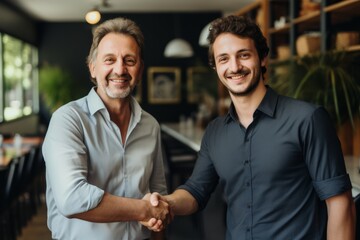 two men shaking hands in a restaurant