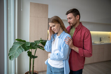 Irritated angry woman, unwilling to speak with man in crisis period of family relations. Caring...