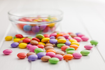 Colorful sweet candies on white table.