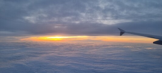 Clouds and sky as seen through window of an aircraft