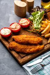 Chicken escalope meal with sauce, vegetables and french fries