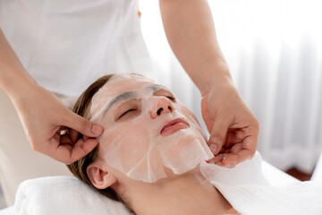 Serene modern daylight ambiance of spa salon, woman customer indulges in rejuvenating with facial...