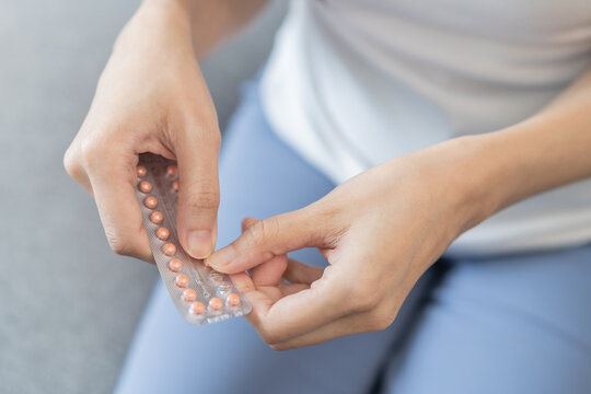 Contraception And Pregnancy Concept Asian Young Woman Hand Open Birth Control Pills, Holding Hormonal Oral Contraceptive Medicine From Blister Pack, Take Pharmaceutical To Prevention Virus Sex Disease