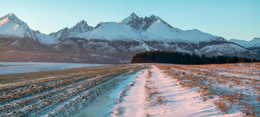 Farm fields in Slovakia in winter scenery with the Tatras in the background