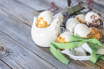 Easter still life with eggs decorated by hand on a wooden surface.
