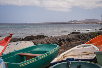 Fototapeta premium Stranded boats at the jetty in the village of Arrieta. Lanzarote, Canary Islands, Spain