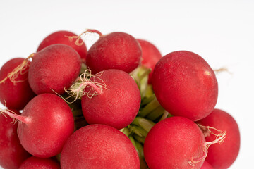 A bundle of fresh radish on a white background. Vegetarian and diet concept.