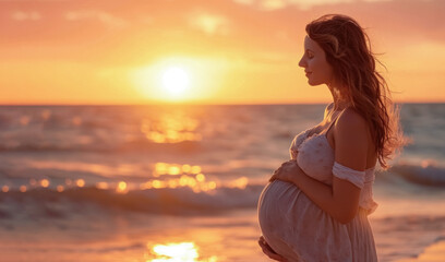 A pregnant woman in a delicate dress against the background of a sea sunset hugs her stomach. The beauty of motherhood