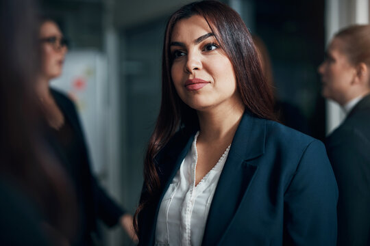 Businesswoman talking with a female colleague in an office boardroom
