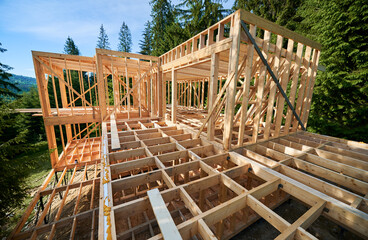 Under-construction residential wooden frame building. Initiation of new construction project for...