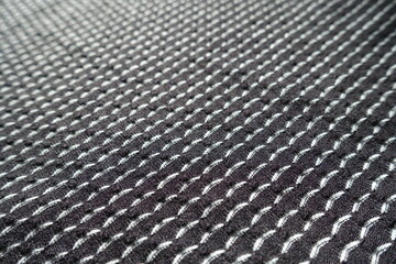 Closeup of black and white jersey fabric with geometric pattern