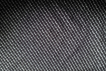 Top view of black and white jersey fabric with geometric pattern