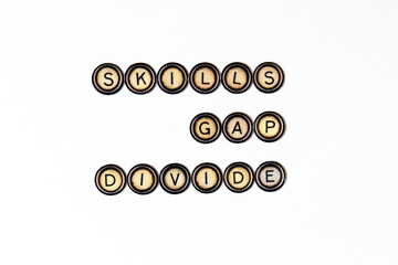 Skills Gap Divide spelt out using vintage fridge magnets over a white paper background.