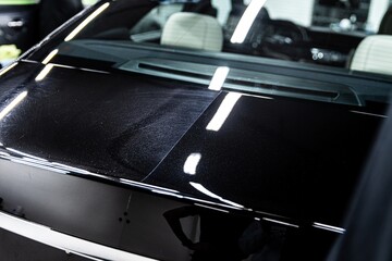 Stunning glossy finish on a luxury car hood, showcasing meticulous detailing work and high-class...