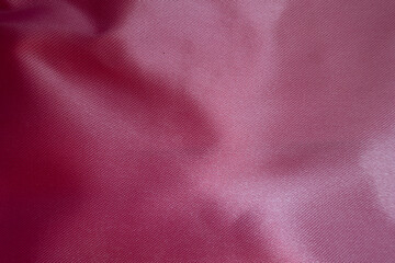 Close view of cold pink satin polyester fabric