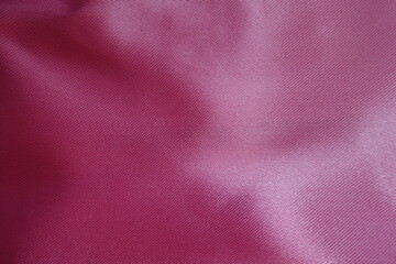 Macro of cold pink satin polyester fabric