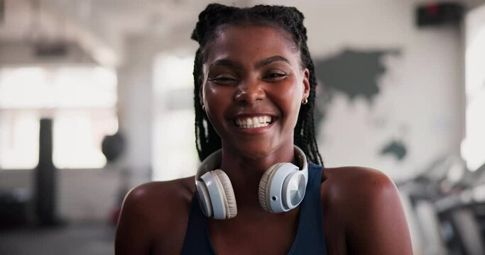 Fitness, face and happy black woman at gym for morning workout, exercise or wellness. Training, portrait and female athlete at a sports center for health, routine or body goals with music headphones