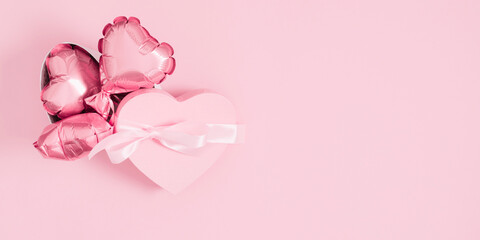 Fototapeta na wymiar Pink background with pink hearts balloons and gift box. Valentine's day concept