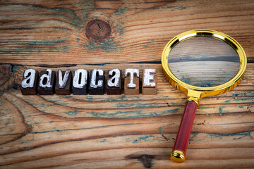 ADVOCATE. Alphabet letters on wood texture background