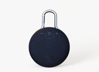 Waterproof round black speaker with carabiner. Digital music and sound concept. Mini, suitable for...